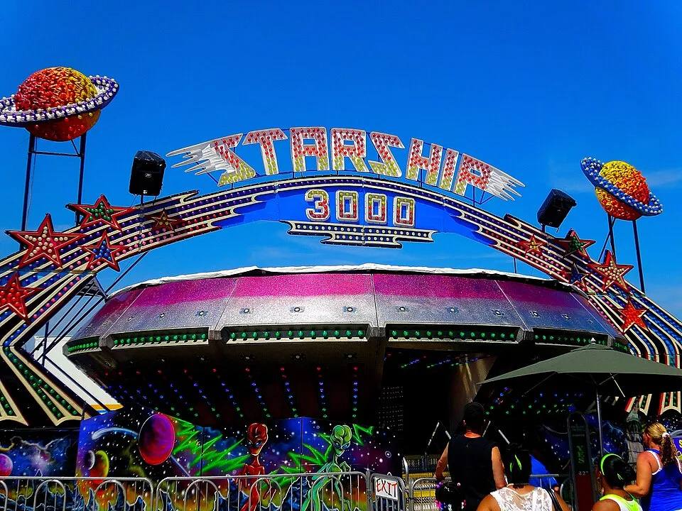 Gravitron spinning spaceship carnival ride with lit marquee — carnival ride rental Los Angeles