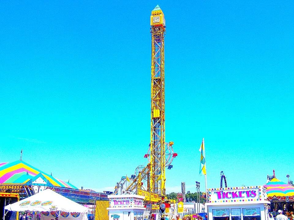 Super Shot drop tower thrill ride above a carnival midway — fair ride rental Los Angeles